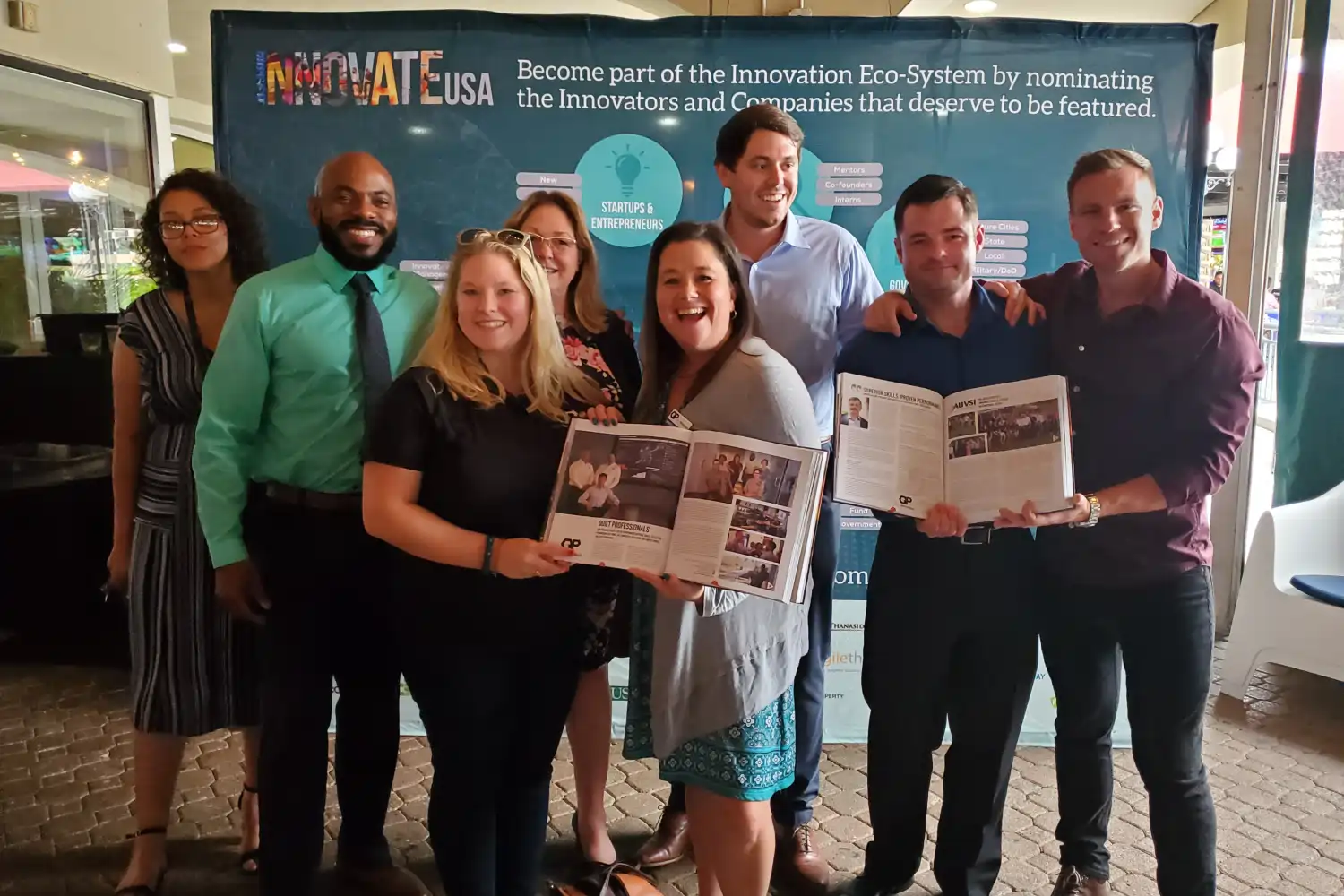 An Experia book launch event where featured members and guests celebrate the publication, creating lasting memories and community pride